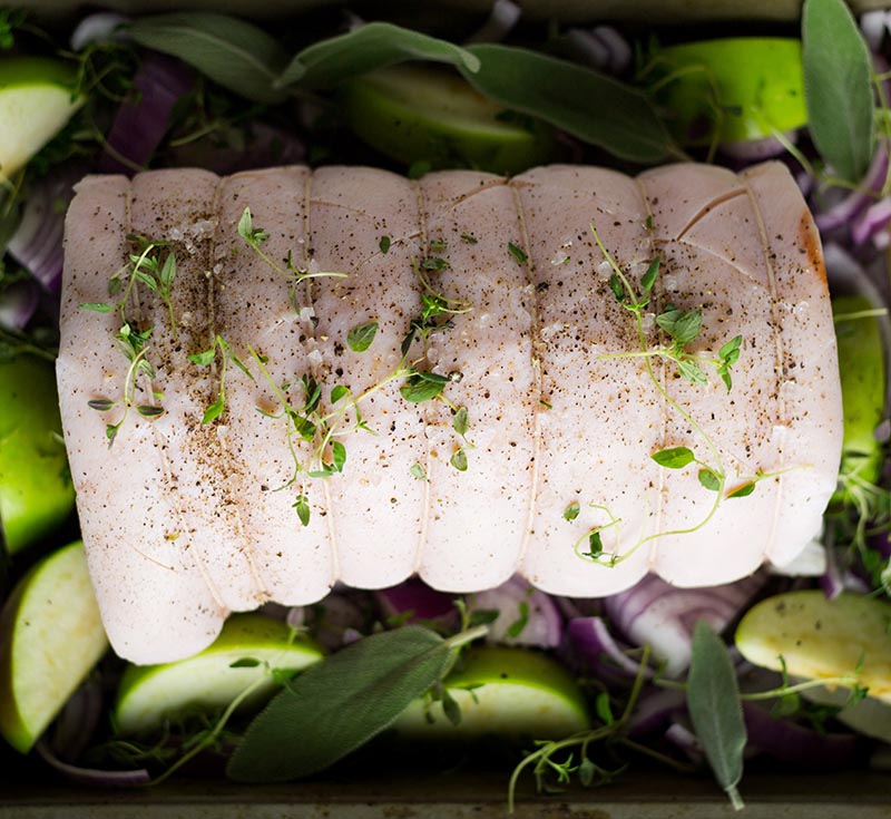 Loin of pork in tin with apples, onions, thyme and sage for roas