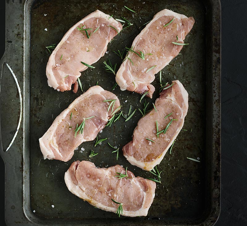 Raw pork loin steaks overhead