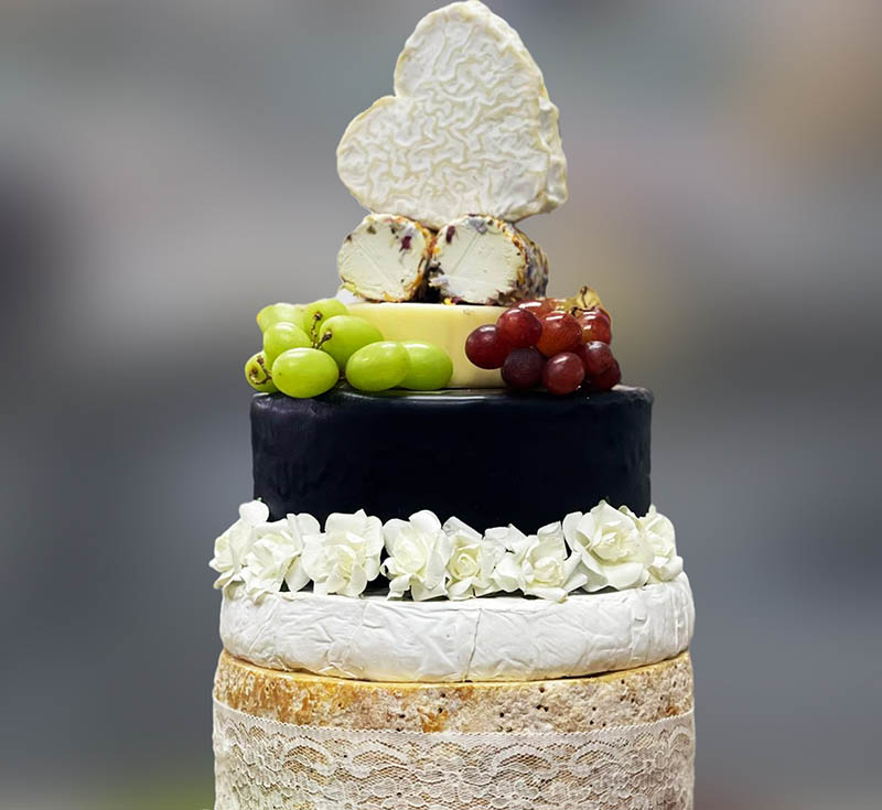 Cheese Celebration Cake-Coeur De Neufchâtel , 2 x Goat’s Cheese Logs, Little Lincoln Imp, 2kg Snowdownia Black Bomber, 1kg Cornish Brie, Base - 4kg Colsten Bassett Stilton